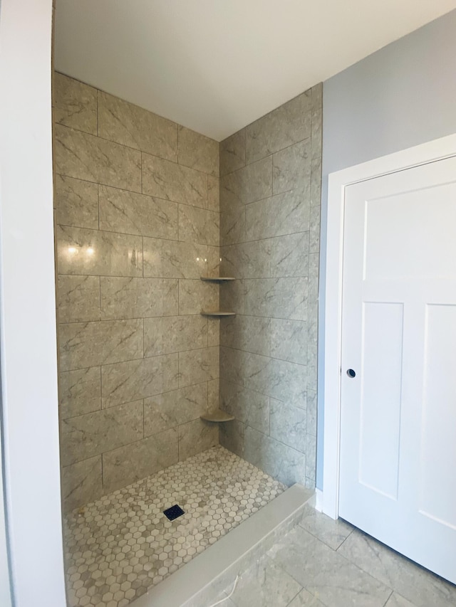 bathroom with a tile shower