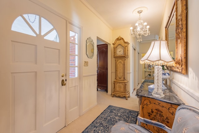 entrance foyer with a notable chandelier, light carpet, and crown molding