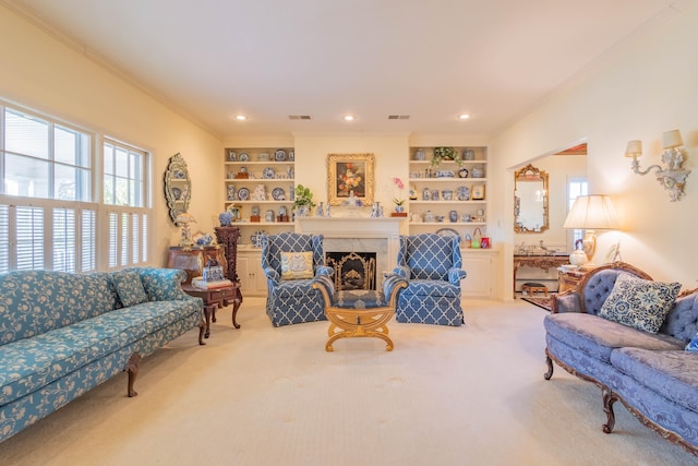 carpeted living room featuring built in shelves and ornamental molding