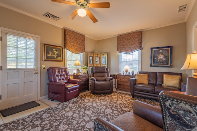 tiled living room with ceiling fan, plenty of natural light, and ornamental molding