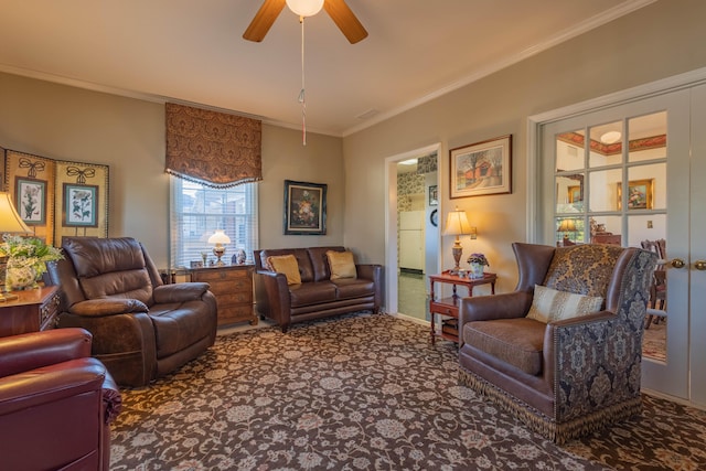 living room with ceiling fan, crown molding, and carpet floors