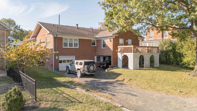 rear view of property featuring a yard and a deck