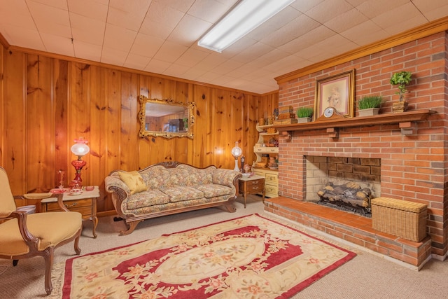 living room featuring a fireplace, carpet floors, wooden walls, and crown molding