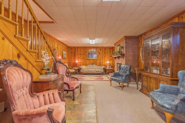 living area featuring wood walls and a brick fireplace