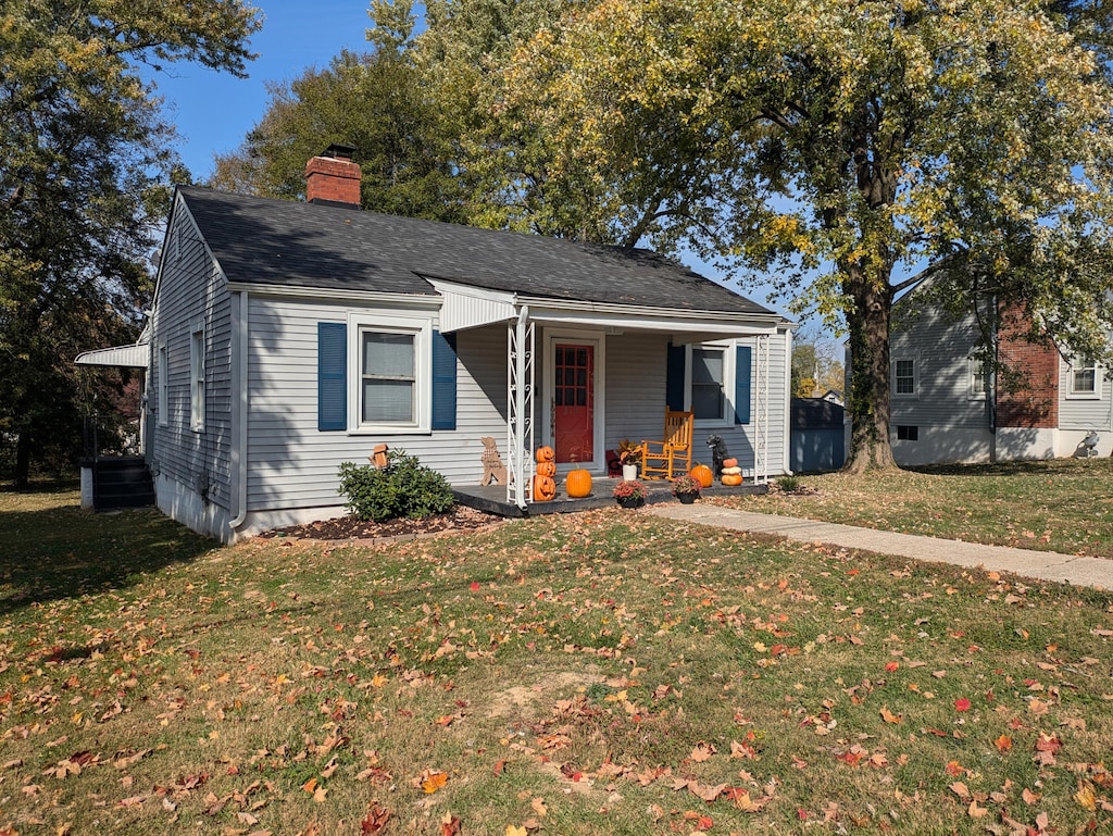 bungalow-style home featuring a porch and a front yard