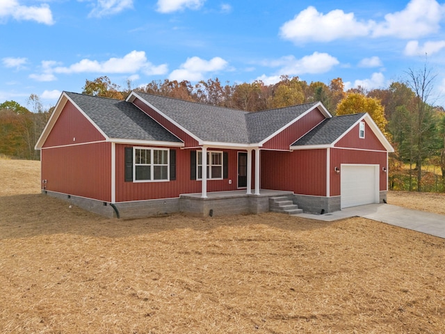 view of front of property featuring covered porch and a garage