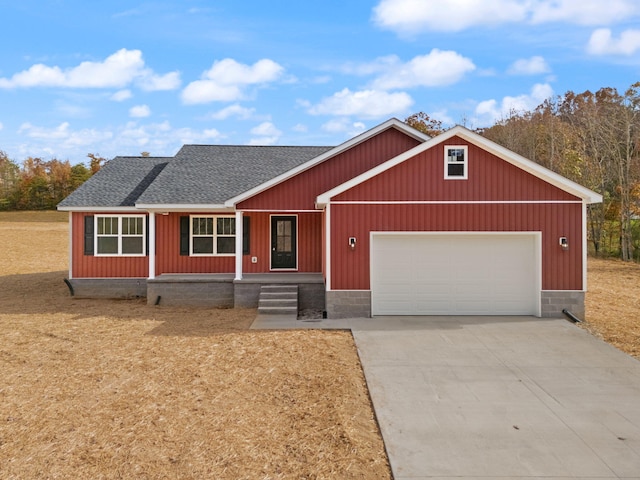 view of front of property with a garage, driveway, a shingled roof, and a porch