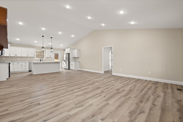 unfurnished living room with high vaulted ceiling, recessed lighting, a sink, baseboards, and light wood finished floors