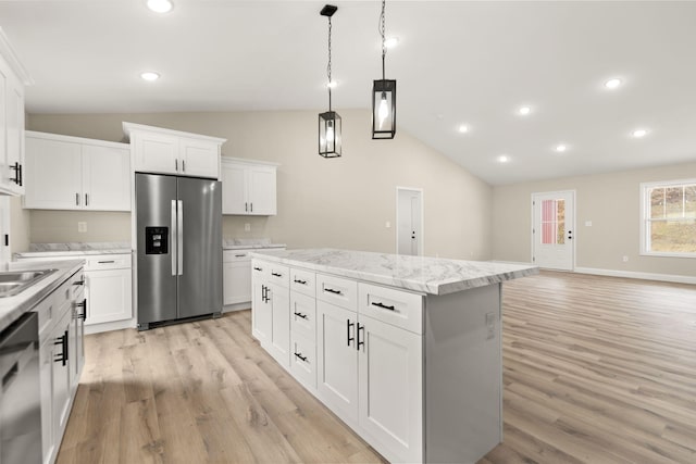 kitchen with lofted ceiling, stainless steel appliances, hanging light fixtures, light wood-type flooring, and a center island