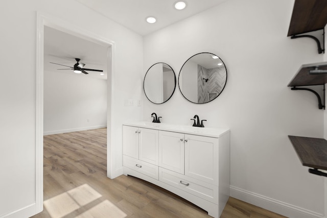 bathroom featuring recessed lighting, wood finished floors, and baseboards