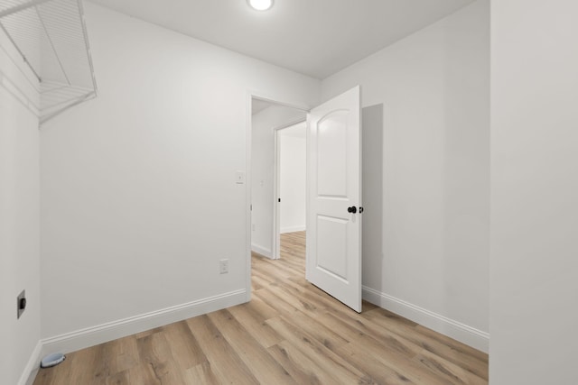 interior space featuring light wood-style floors and baseboards