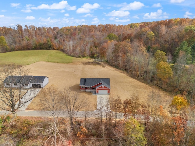 drone / aerial view featuring a view of trees