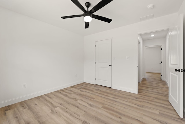 unfurnished bedroom with a ceiling fan, light wood-style flooring, and baseboards