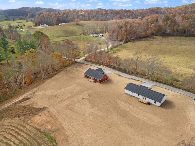 drone / aerial view featuring a rural view and a forest view