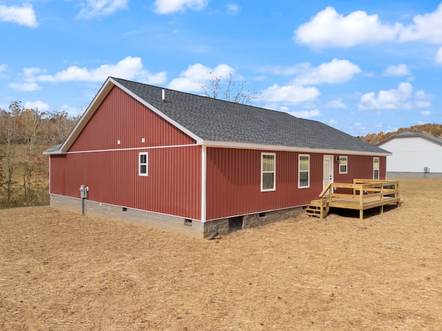 exterior space with crawl space, roof with shingles, and a wooden deck