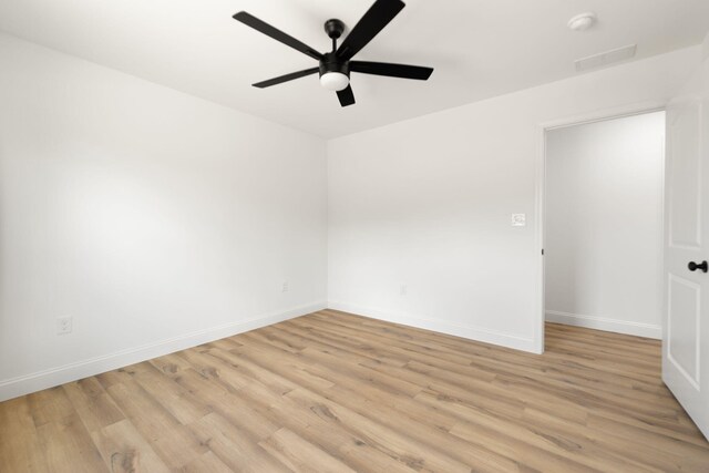 unfurnished room featuring baseboards, ceiling fan, and light wood finished floors