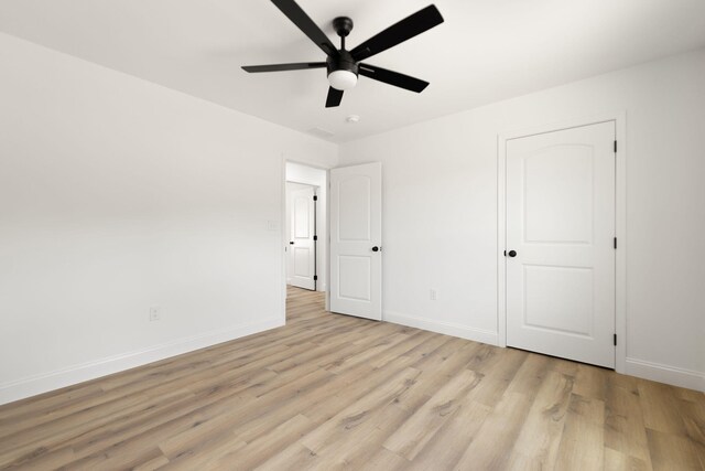 unfurnished bedroom with a ceiling fan, baseboards, and light wood finished floors