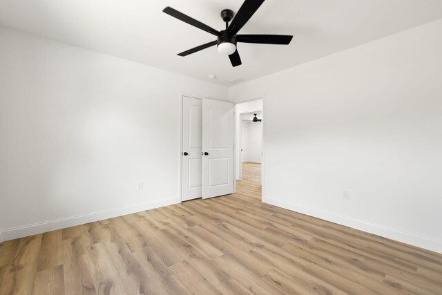 interior space with a ceiling fan, light wood-type flooring, and baseboards