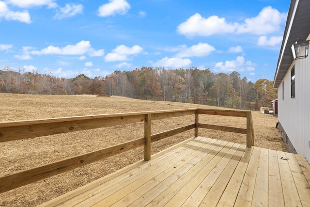 wooden deck with a wooded view