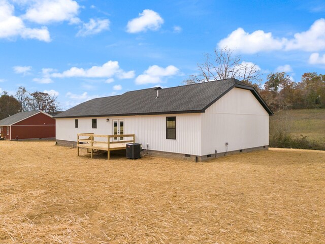 rear view of house with french doors, a shingled roof, central AC unit, crawl space, and a wooden deck