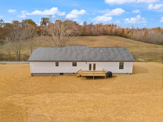 rear view of house with french doors, crawl space, and a shingled roof