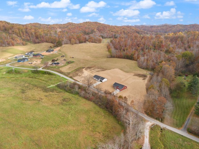 drone / aerial view featuring a wooded view