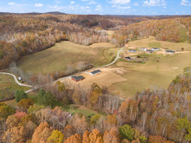 birds eye view of property featuring a wooded view