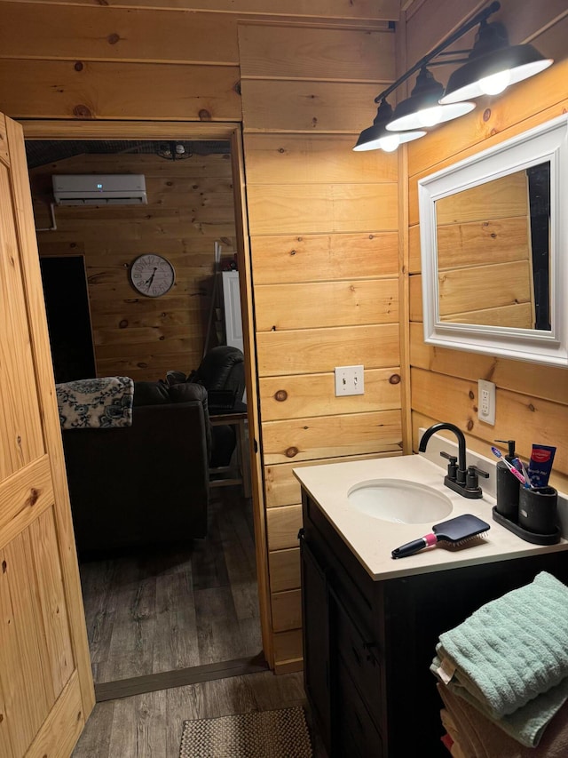 bathroom featuring an AC wall unit, vanity, hardwood / wood-style floors, and wooden walls