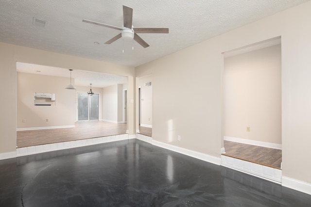 unfurnished living room featuring ceiling fan, hardwood / wood-style flooring, and a textured ceiling