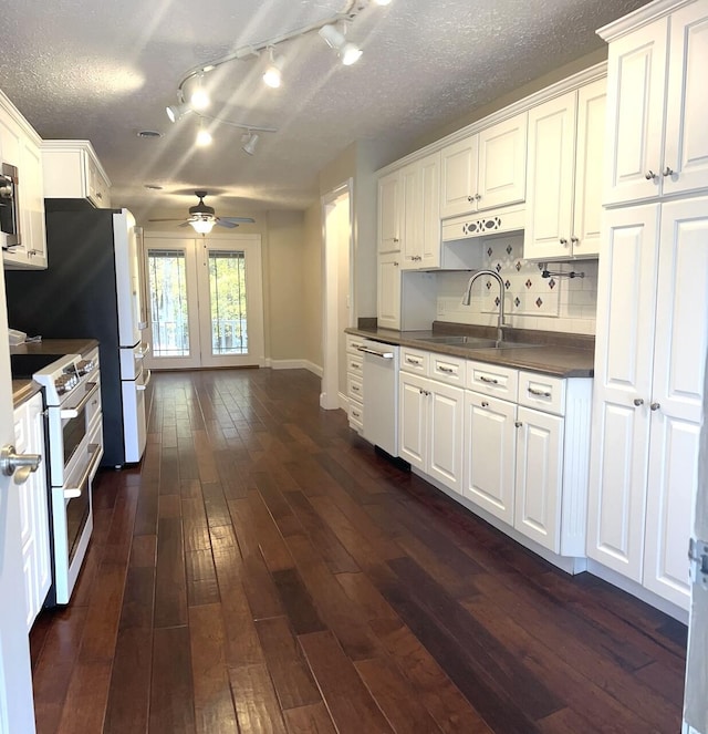 kitchen featuring white cabinetry, ceiling fan, dark wood-type flooring, and appliances with stainless steel finishes