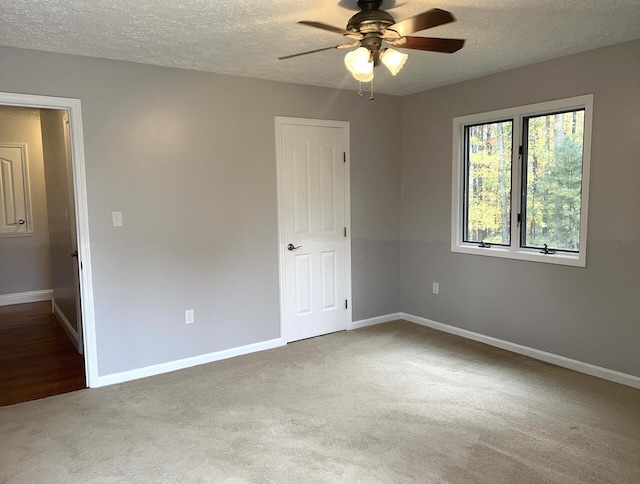 unfurnished room featuring carpet, a textured ceiling, and ceiling fan