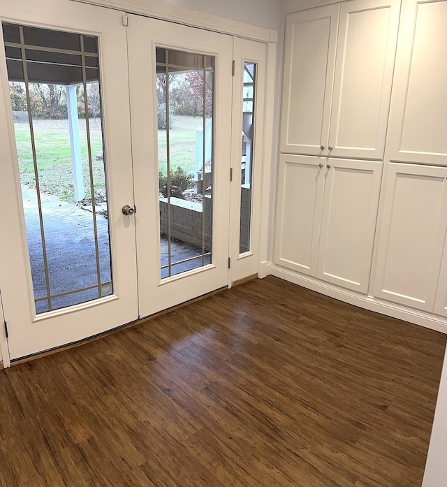 doorway with french doors and dark wood-type flooring