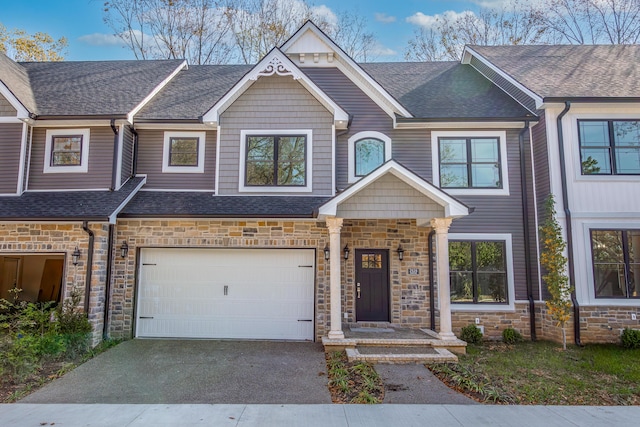 2528 Leland Ln, Lexington, KY 40503 - townhome / multi-family property featuring stone siding, asphalt driveway, a garage, and a shingled roof