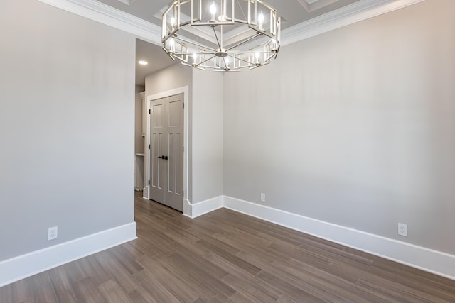 unfurnished room with crown molding, a notable chandelier, and hardwood / wood-style floors