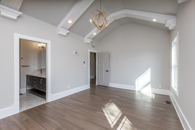 unfurnished living room with sink, high vaulted ceiling, an inviting chandelier, and dark hardwood / wood-style floors