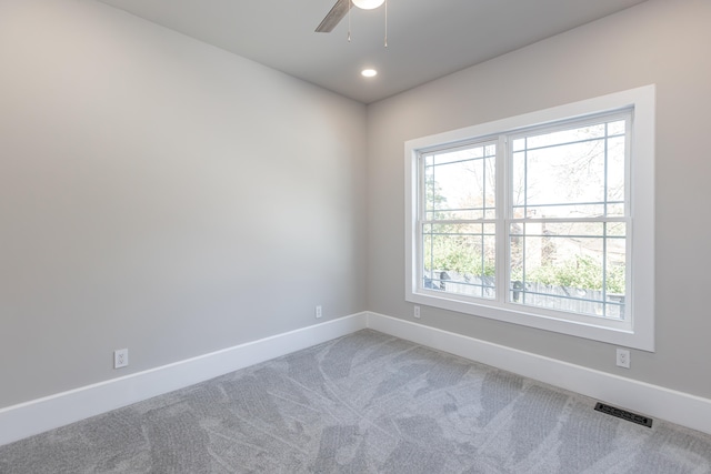 unfurnished room with carpet floors and ceiling fan