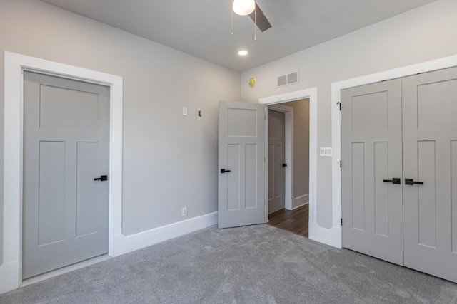 unfurnished bedroom featuring a closet, ceiling fan, and dark carpet