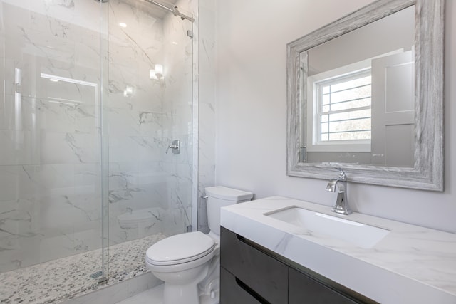 bathroom with toilet, a shower with shower door, and vanity