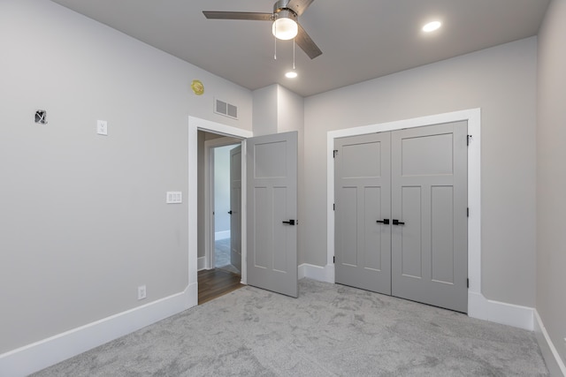 unfurnished bedroom with a closet, ceiling fan, and light colored carpet