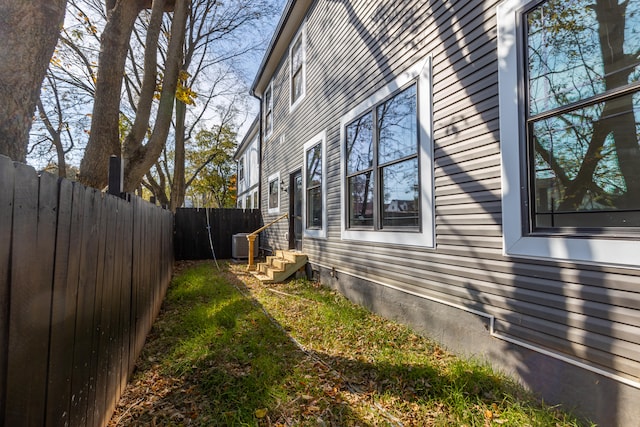 view of side of property featuring central air condition unit