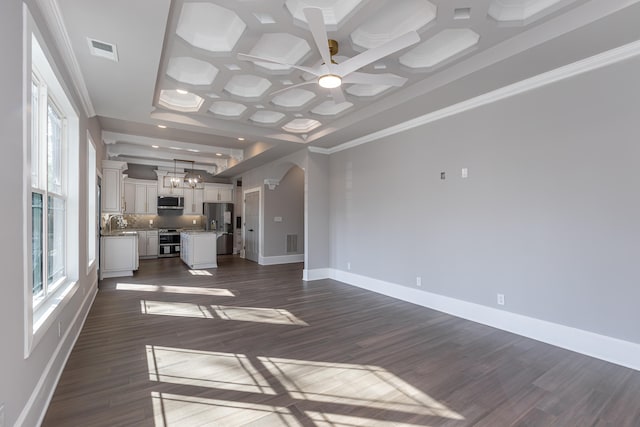 unfurnished living room with beam ceiling, ceiling fan, dark hardwood / wood-style flooring, crown molding, and coffered ceiling