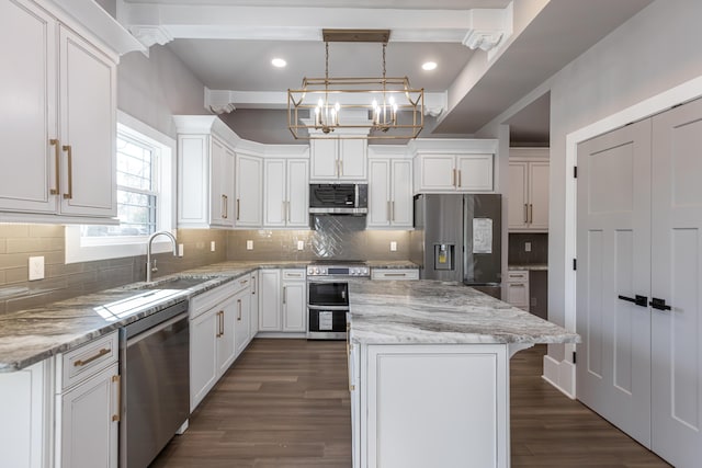 2528 Leland Ln, Lexington, KY 40503 - kitchen with appliances with stainless steel finishes, a sink, a kitchen island, white cabinetry, and recessed lighting