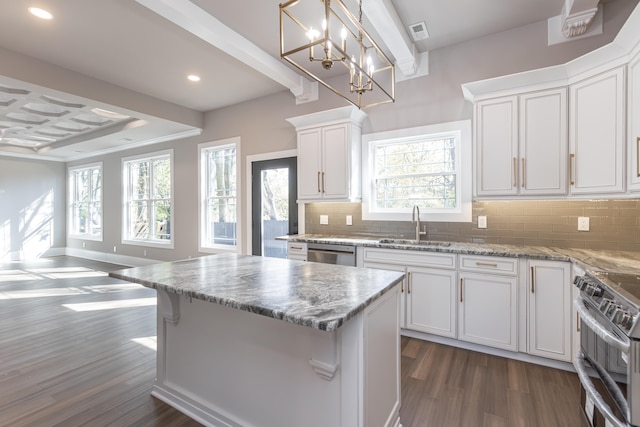 kitchen with tasteful backsplash, white cabinetry, dark hardwood / wood-style floors, sink, and stainless steel appliances