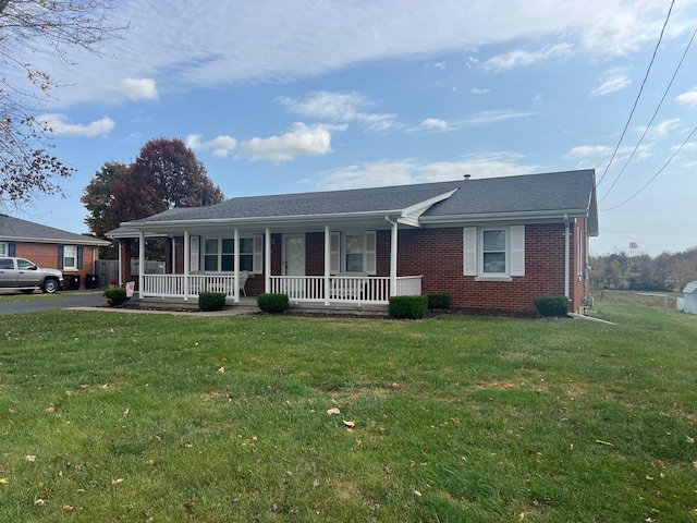 ranch-style home featuring a front lawn and covered porch