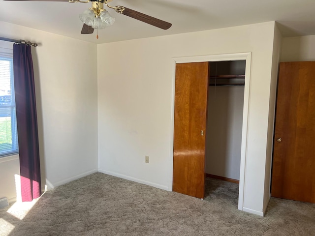 unfurnished bedroom featuring a closet, light colored carpet, and ceiling fan