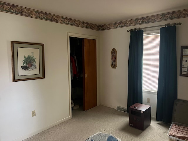 carpeted bedroom with a closet