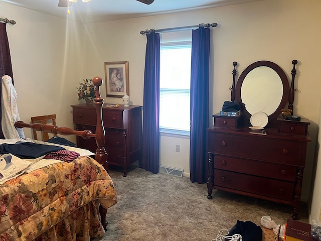 bedroom featuring light carpet and ceiling fan