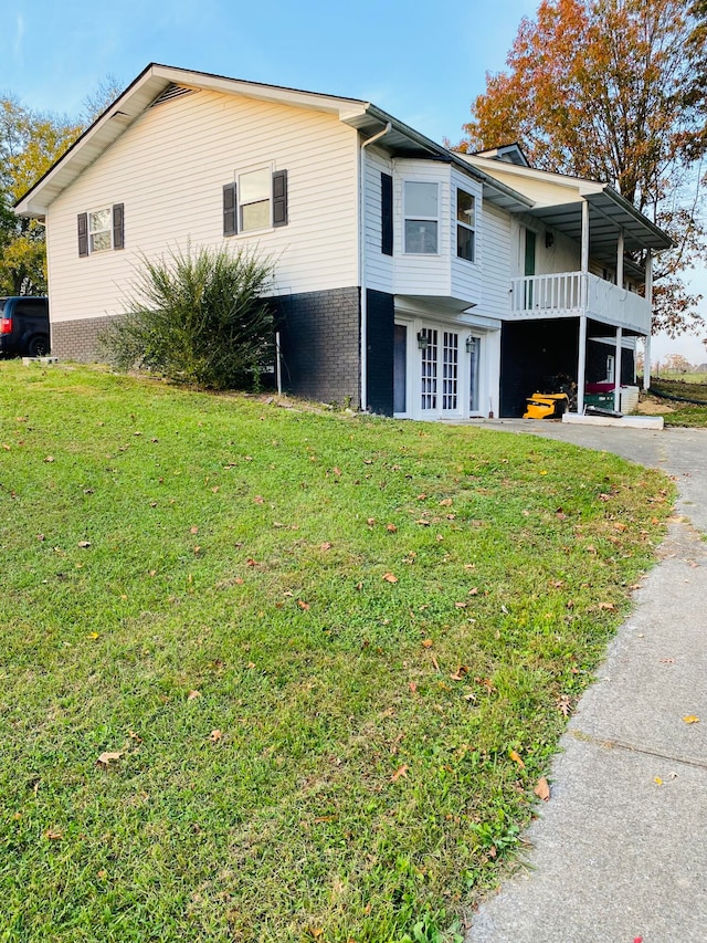 view of home's exterior featuring french doors and a yard