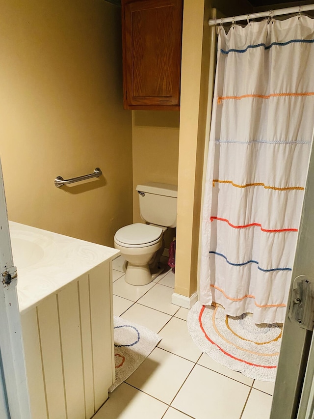 bathroom featuring tile patterned flooring, vanity, toilet, and a shower with shower curtain