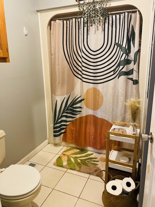 bathroom with toilet and tile patterned floors